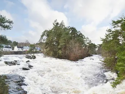 a river with white rapids on top of it at Gracedieu in Killin