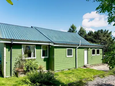 a green house with a green roof at The Heron in Ardentinny