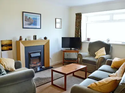 a living room with two couches and a fireplace at Baravullin in Benderloch
