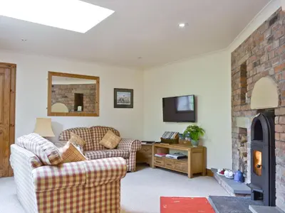 a living room with two couches and a fireplace at Old Stones in Glendevon