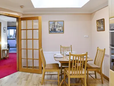 a dining room with a table and chairs at Eilean Donan in Kirknewton