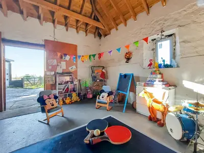 a room with a drum set and toys in it at Old Barn Farmhouse - Cc in Uplawmoor
