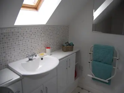 a white bathroom with a sink and a window at Bramble Cottage 1, 2 & 3 in Lochdon