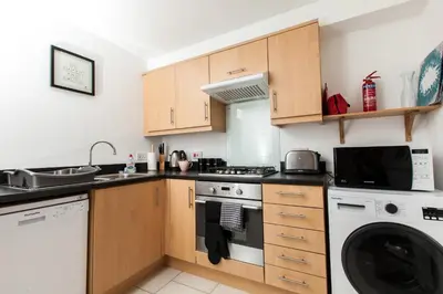 a kitchen with a stove and a dishwasher at Dunfermline - Premium Two Bedroom Apartment - KW in Dunfermline