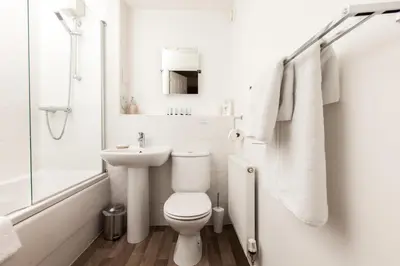 a white bathroom with a toilet and a sink at Dunfermline - Premium Two Bedroom Apartment - KW in Dunfermline
