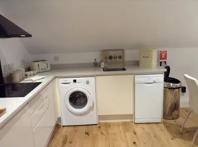 a kitchen with a washer and a washing machine at The BurnHowf apartment in Balloch