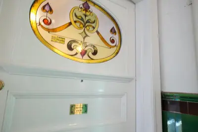a clock on a wall above a door at PREMIER - Crathie View Apartment in Glasgow
