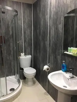 a bathroom with a toilet and a sink and a shower at Lanark Residence in Edinburgh