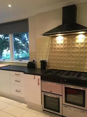 a kitchen with a stove top oven next to a window at Lanark Residence in Edinburgh