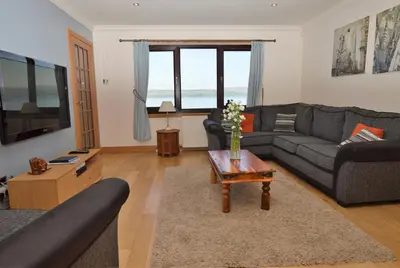a living room with couches and a coffee table at Clydeside Villa in Dunoon