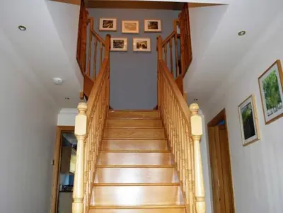a wooden staircase in a home with wooden floors at Clydeside Villa in Dunoon