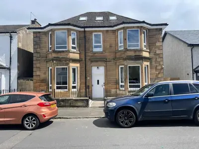 two cars parked in front of a house at Elder Park Apartments in Glasgow
