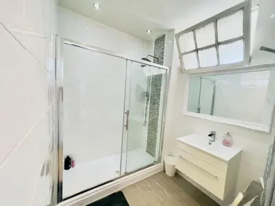 a bathroom with a glass shower and a sink at Lauriston Park in Edinburgh