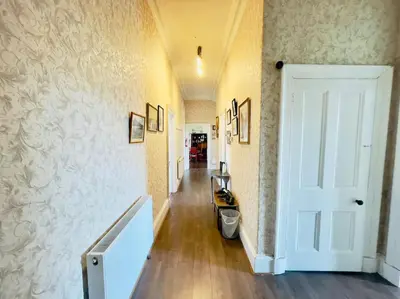 a hallway with a hallway leading to a room with a door at Lauriston Park in Edinburgh