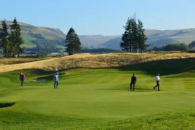 a group of people playing golf on a golf course at The Pines - Luxury 3-Bed Apartment Near Golf & Spa, Gleneagles, Auchterarder in Auchterarder