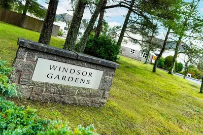 a sign for windsor gardeners in a yard at The Pines - Luxury 3-Bed Apartment Near Golf & Spa, Gleneagles, Auchterarder in Auchterarder