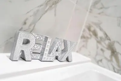 a metal block spelling out the word art on a shelf at The Pines - Luxury 3-Bed Apartment Near Golf & Spa, Gleneagles, Auchterarder in Auchterarder