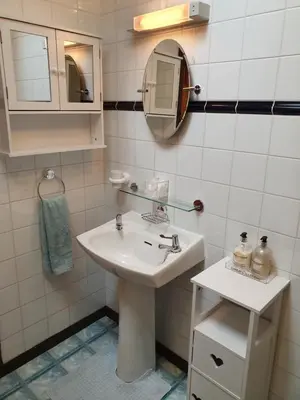 a bathroom with a sink and a mirror at Crailloch Croft Cottages in Stranraer