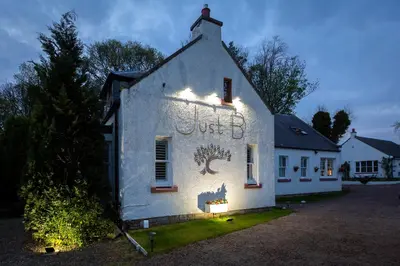 a white building with a sign on the side of it at JustB Edinburgh in Edinburgh