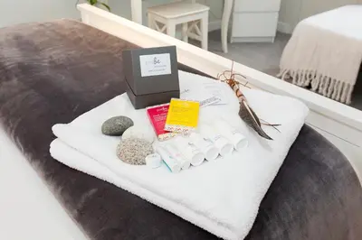 a table with towels and a box on a bed at JustB Edinburgh in Edinburgh