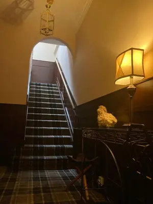 a stairway with a lamp and a staircase with a stair case at Norwood Guesthouse-Loch Lomond in Balloch