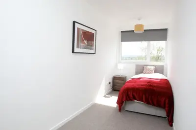 a bedroom with a bed and a window at Southside Apartment Glasgow in Glasgow
