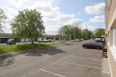 a street with cars parked in a parking lot at Southside Apartment Glasgow in Glasgow
