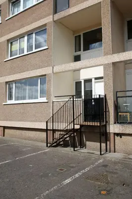 a building with a staircase in a parking lot at Southside Apartment Glasgow in Glasgow
