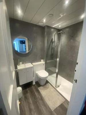 a bathroom with a shower and a toilet and a sink at Edinburgh West Side Hostel in Edinburgh