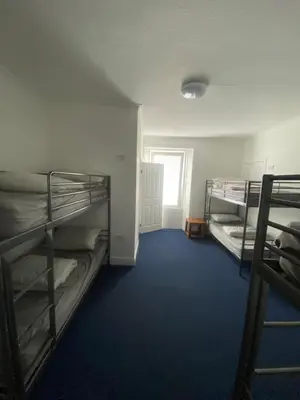 a room with two bunk beds and a window at Edinburgh West Side Hostel in Edinburgh
