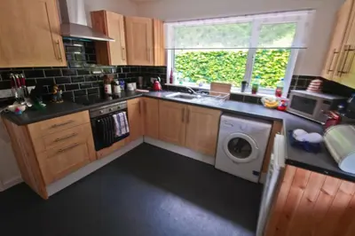 a kitchen with a sink and a washing machine at Fonn Na Mara in Campbeltown