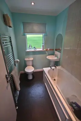 a bathroom with a tub and a toilet and a sink at Fonn Na Mara in Campbeltown