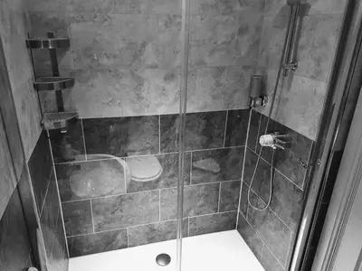 a bathroom with a shower with a glass door at Boat House Super Suites in Rothesay