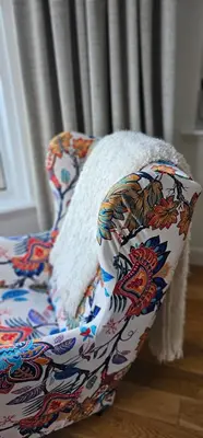 a couch with a blanket on it in a room at Boat House Super Suites in Rothesay