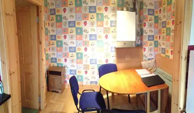 a small dining room with a table and chairs at House for Groups & Contractors Kilmarnock in Kilmarnock