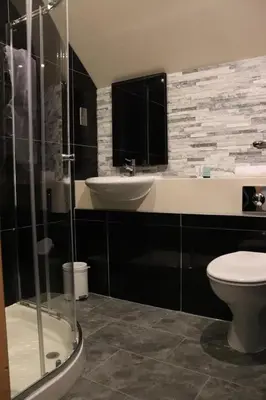 a bathroom with a toilet and a sink at Loch Long Hotel in Arrochar
