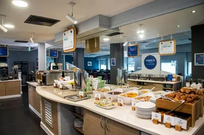 a bakery counter with a lot of food on it at Holiday Inn Express - Glasgow - City Ctr Riverside by IHG in Glasgow