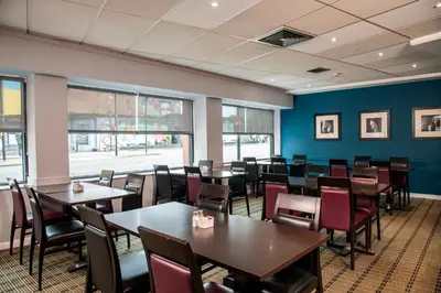 a dining room with tables and chairs and blue walls at Holiday Inn Express - Glasgow - City Ctr Riverside by IHG in Glasgow