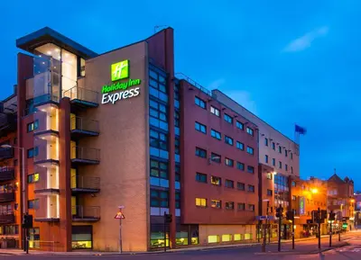 a building with a sign on the side of it at Holiday Inn Express - Glasgow - City Ctr Riverside by IHG in Glasgow