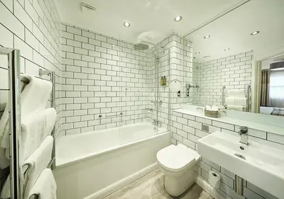 a white bathroom with a tub and a toilet and a sink at Loch Fyne Hotel & Spa in Inveraray