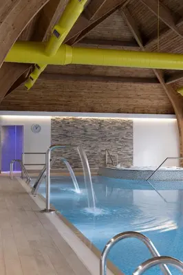 a pool with a water slide in a building at Loch Fyne Hotel & Spa in Inveraray