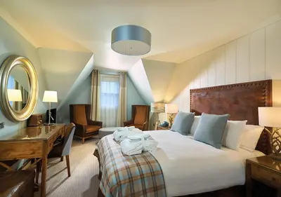 a hotel room with a large bed and a desk at Loch Fyne Hotel & Spa in Inveraray