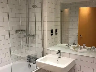 a white bathroom with a sink and a shower at Loch Fyne Hotel & Spa in Inveraray