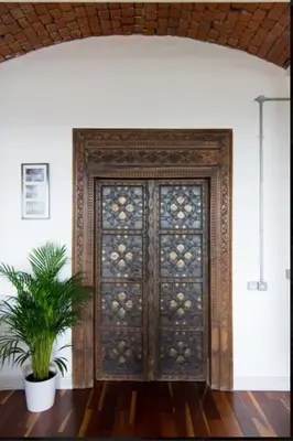 a wooden door with a plant in front of it at Loft Apartment in Port Glasgow