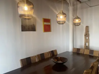 a dining room with a table and pendant lights at Loft Apartment in Port Glasgow