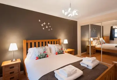a bedroom with a bed with towels on it at Glasgow City Flats - Merchant City in Glasgow