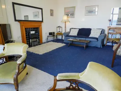 a living room with a couch and a fireplace at The Shieling in Lochranza
