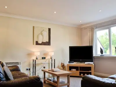 a living room with a couch and a television at Lia Fail in Ballachulish