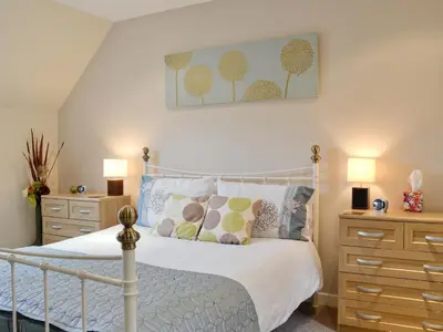 a bedroom with a bed and two nightstands and a bed sidx sidx sidx at Lia Fail in Ballachulish