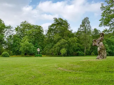a statue of a woman holding a child in a park at Gilminscroft Gatehouse in Sorn